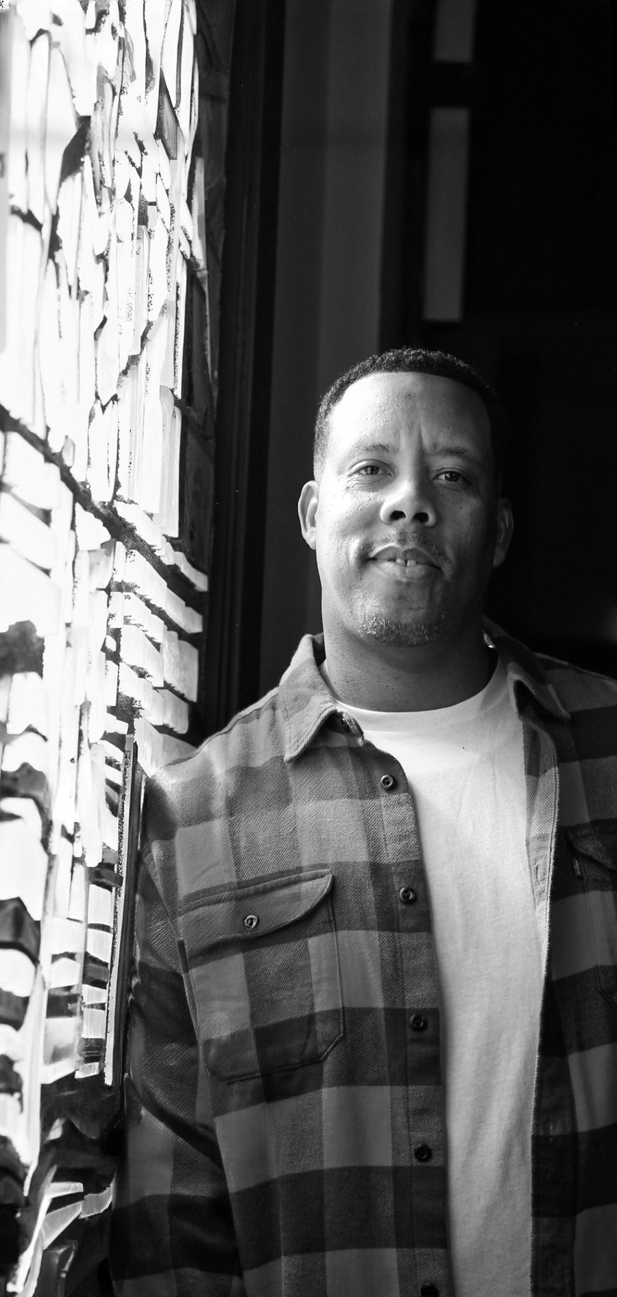 Nisan Stewart, founder of NCS Entertainment, in black and white